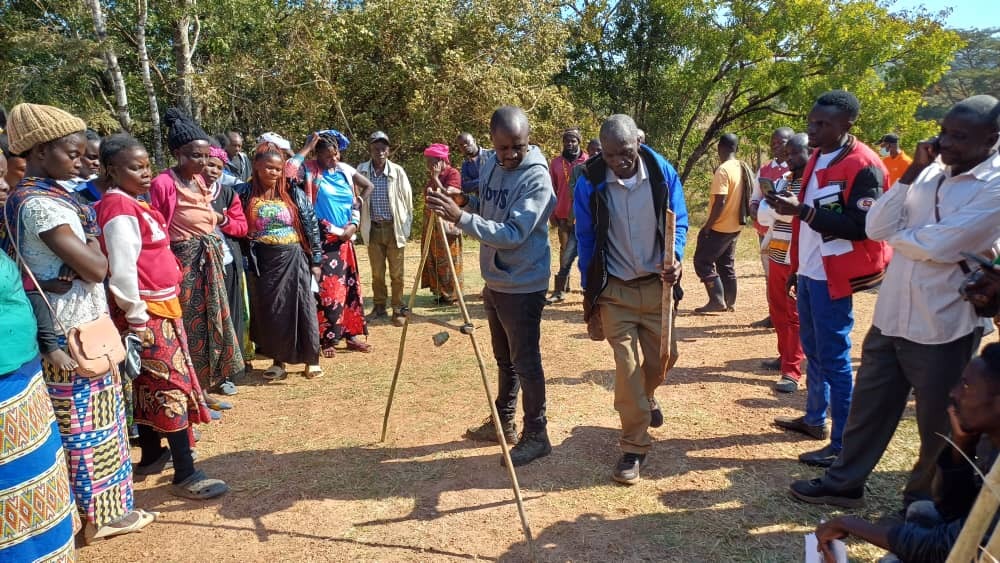 Group of people. One holding an A-frame level.