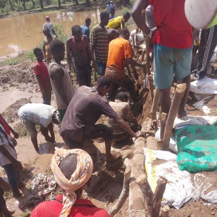 People reinforce river bank