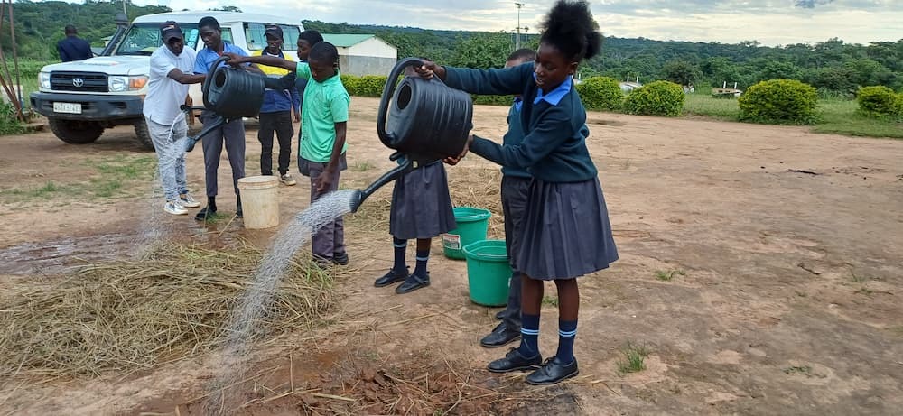 School girl pouring water