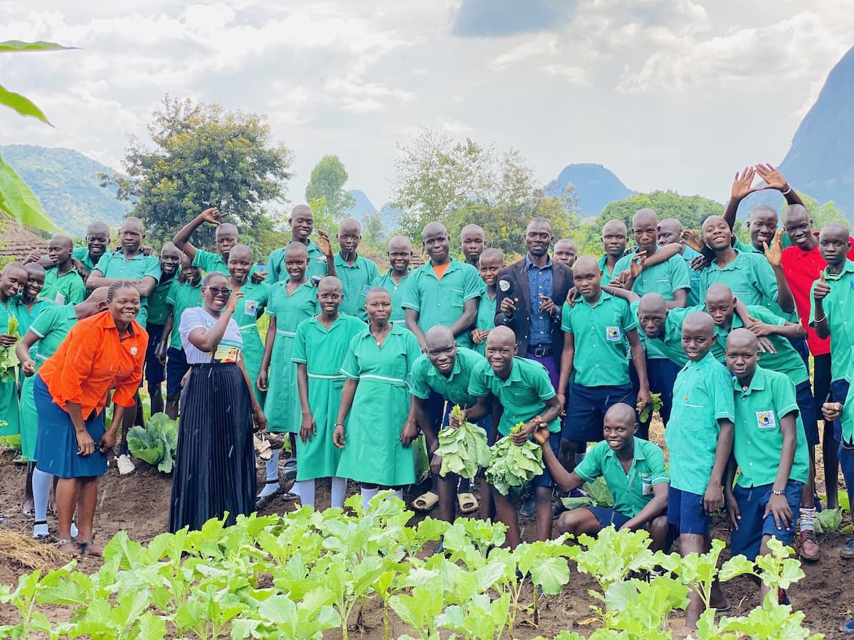 Group of primary school students in a field in Uganda