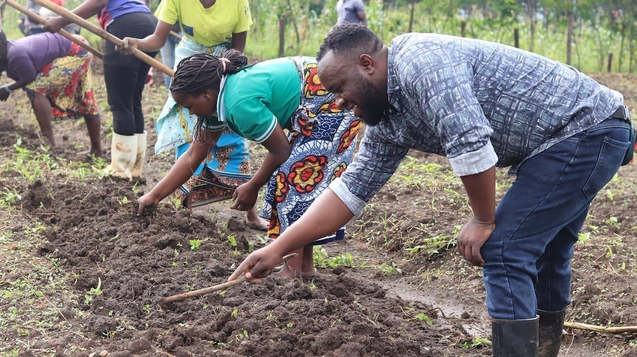 people adding amendments to soil in nakivale