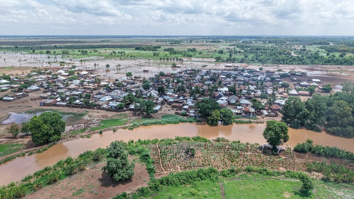 Aerial image of river adjacent to village.